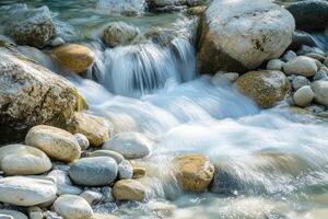 Smooth River Flowing Over Rounded Rocks in a Forest Stream photo