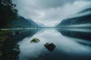 Serene Mountain Lake with Foggy Sky and Reflection photo