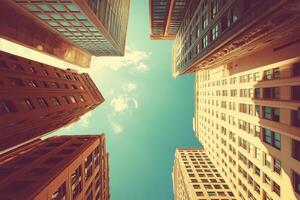 Upward View of Tall Buildings with Blue Sky photo