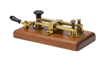A close up of a vintage morse code key on a wooden base with brass components and black handles png