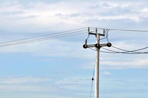 Electric Utility Pole with Power Lines and Cloudy Sky photo