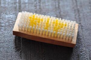 Synthetic brush with wooden handle on the floor photo
