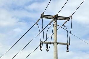 Electric Utility Pole with Power Lines Against Cloudy Sky photo