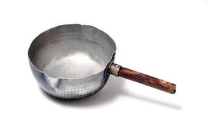 An empty kadhai with its wooden handle photo
