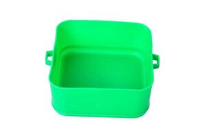 Top view of a bright green plastic storage container placed on white background photo