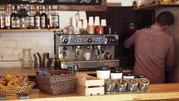 Barista skillfully crafting coffee at the bustling cafe bar video