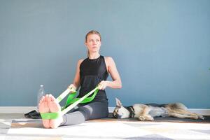 athletic woman doing exercises for arms with resistance band photo