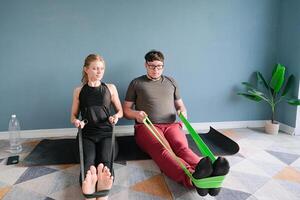 couple training at home using resistance band photo