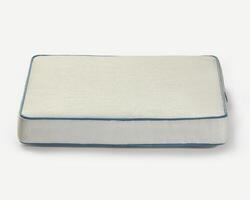 Comfortable pet bed resting on white background photo