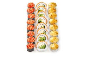 Delicious sushi rolls forming colorful lines on white background photo