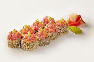 Tempura sushi rolls with spicy tuna, mango, and tobiko, featuring wasabi and ginger photo