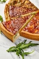 Delicious homemade quiche with salmon and spinach filling sliced and ready to serve photo