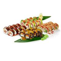 Variety of sushi rolls displayed on banana leaves with sesame seeds and spices photo