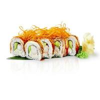 Dragon roll sushi with eel, shrimp, avocado, cream cheese, and sesame seeds displayed on banana leaf photo