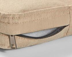 Open zipper showing foam filling of beige fabric cushion photo