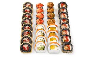 Four rows of delicious uramaki sushi rolls with various toppings presenting vibrant colors photo