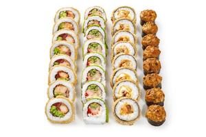 Four rows of delicious tempura and roasted sushi rolls displaying on white background photo