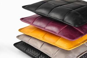 Stack of colorful leather pillows creating a cozy atmosphere photo