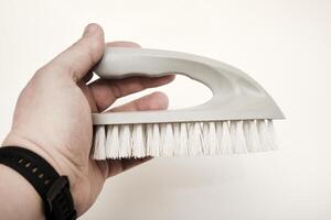An apparel brush grasped in hand. A tidying brush. photo
