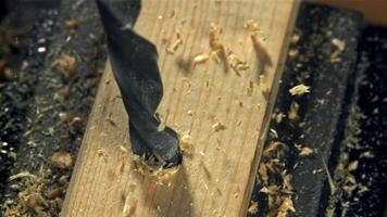 Drilling a wooden block in the workshop. Filmed on a high-speed camera at 1000 fps. High quality FullHD footage video