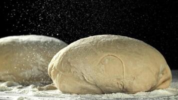 Flour falls on the dough. Filmed on a high-speed camera at 1000 fps. High quality FullHD footage video