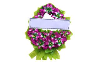Flower wreath with long paper card for adding text, isolated on white background. Concept, Wreaths for paying respect to the deceased in Thai culture at funerals. photo