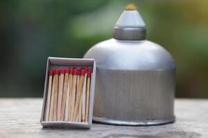 Stainless steel alcohol burner lantern. Laboratory lamp and box of matches. Concept, equipment or tool for science experiment. Educational toolkit photo