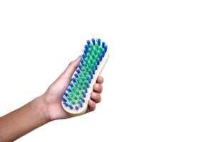 Hand hold brush for scrub dirty cloth, isolated on white background. Concept, equipment for washing, scrubbing and cleaning dirty cloth, carpet or surface. Daily chores tool. photo