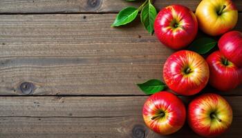Top view of red and green apples on wood table, clean organic layout photo
