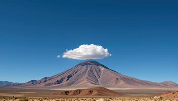solitary cloud atop a desert peak. photo