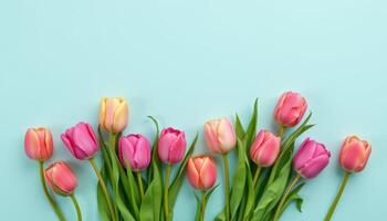 Pastel background with decorative tulips arranged vertically, soft spring theme photo