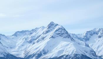 Majestic mountain range, snow covered peaks, tranquil sky, frozen landscape. photo
