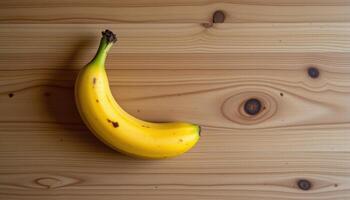 Top view of sweet banana on wooden table, warm natural light, minimal styling photo