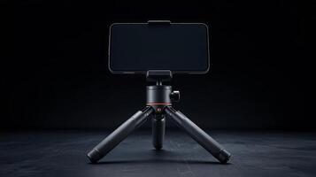 A smartphone mounted on a mini tripod, set against a dark background, showcasing mobile photography setup photo