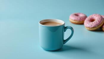 Coffee or cocoa in a blue mug on a blue background with donuts, space for text. photo. photo