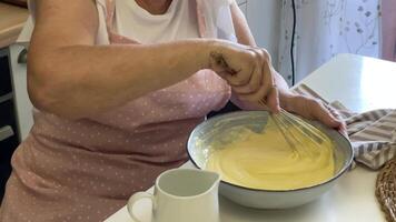 Baker adding milk and whisking ingredients video
