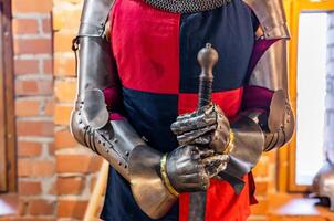 A man in armor holding a sword photo
