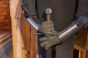 A close up of a medieval armor and a sword photo