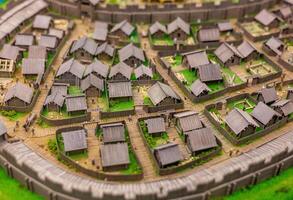 A model of a medieval town with a castle in the background photo