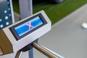 A person is standing in front of a metal detector photo