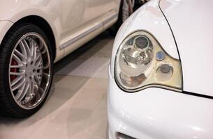 A close up of a white car with a headlight photo