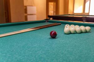 A pool table with a ball and sticks photo