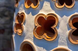 A close up of a large pot with many holes photo