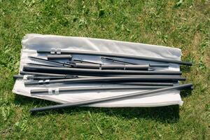 A bag of black and white sticks on the grass photo