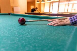 Russian billiard balls, cue, triangle, chalk on a table Green cloth Top view Copy space photo