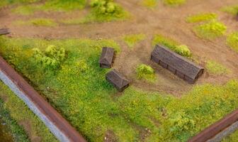 A miniature model of a farm with a barn and a small house photo