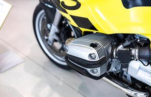 A close up of a yellow motorcycle with a black and yellow checkered flag photo