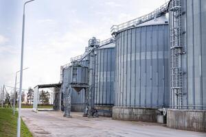 A large industrial building with a large silo on the side photo