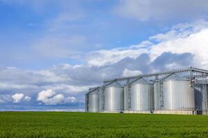 Large silos in a field with a blue sky photo