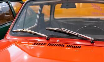 A close up of a car with a windshield and a hood photo